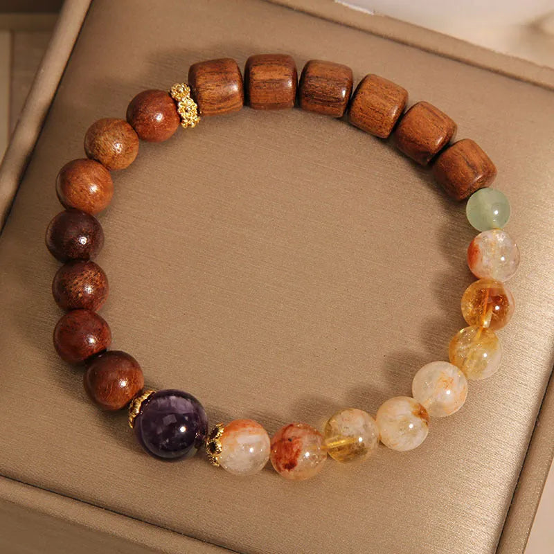 Women's adjustable crystal bracelet with yellow tower crystal, ebony amethyst, pearls, and rhinestones.