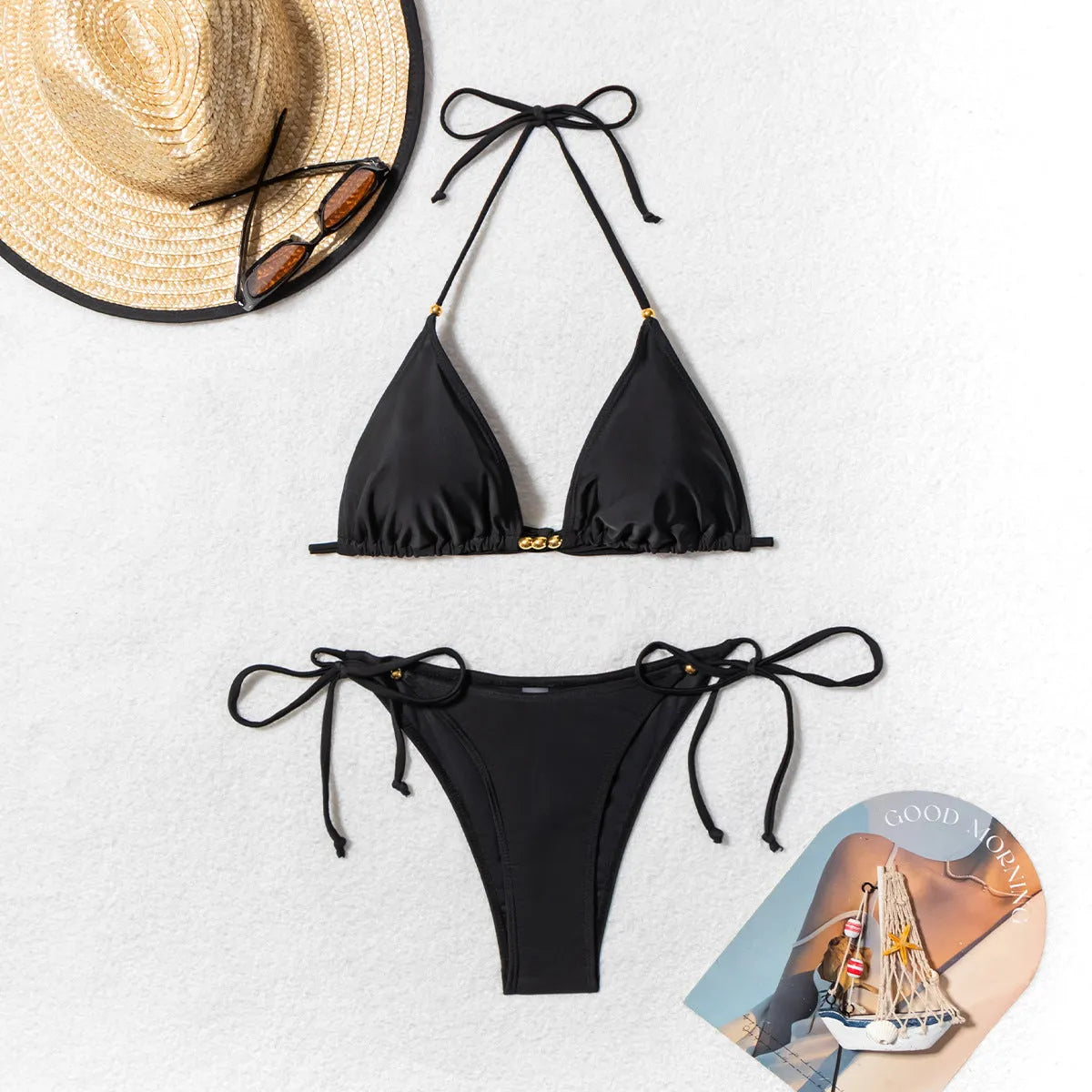 Black women's two-piece bikini swimsuit with a silver metal bead decorative detail on the front.