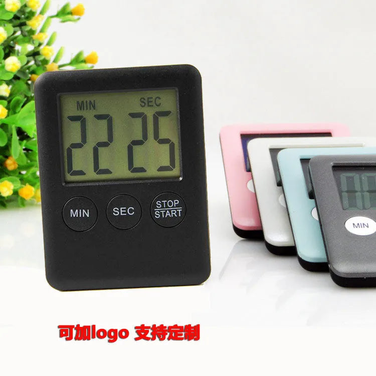 Black and white kitchen timer with digital display and magnetic back