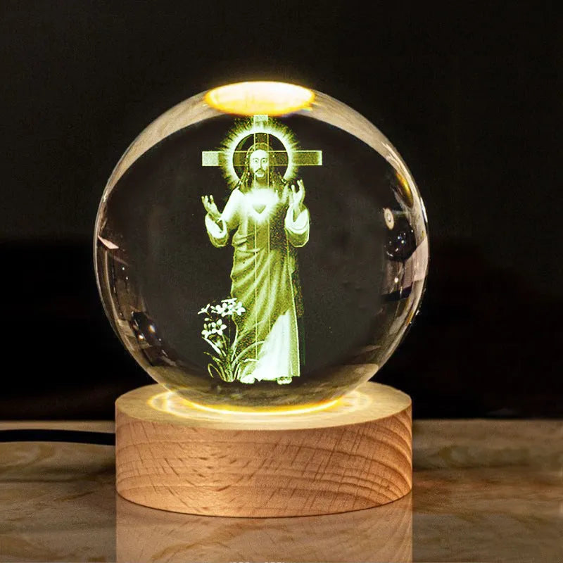White crystal ball desk lamp on wooden base with warm light, showing religious symbol options.