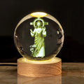 White crystal ball desk lamp on wooden base with warm light, showing religious symbol options.