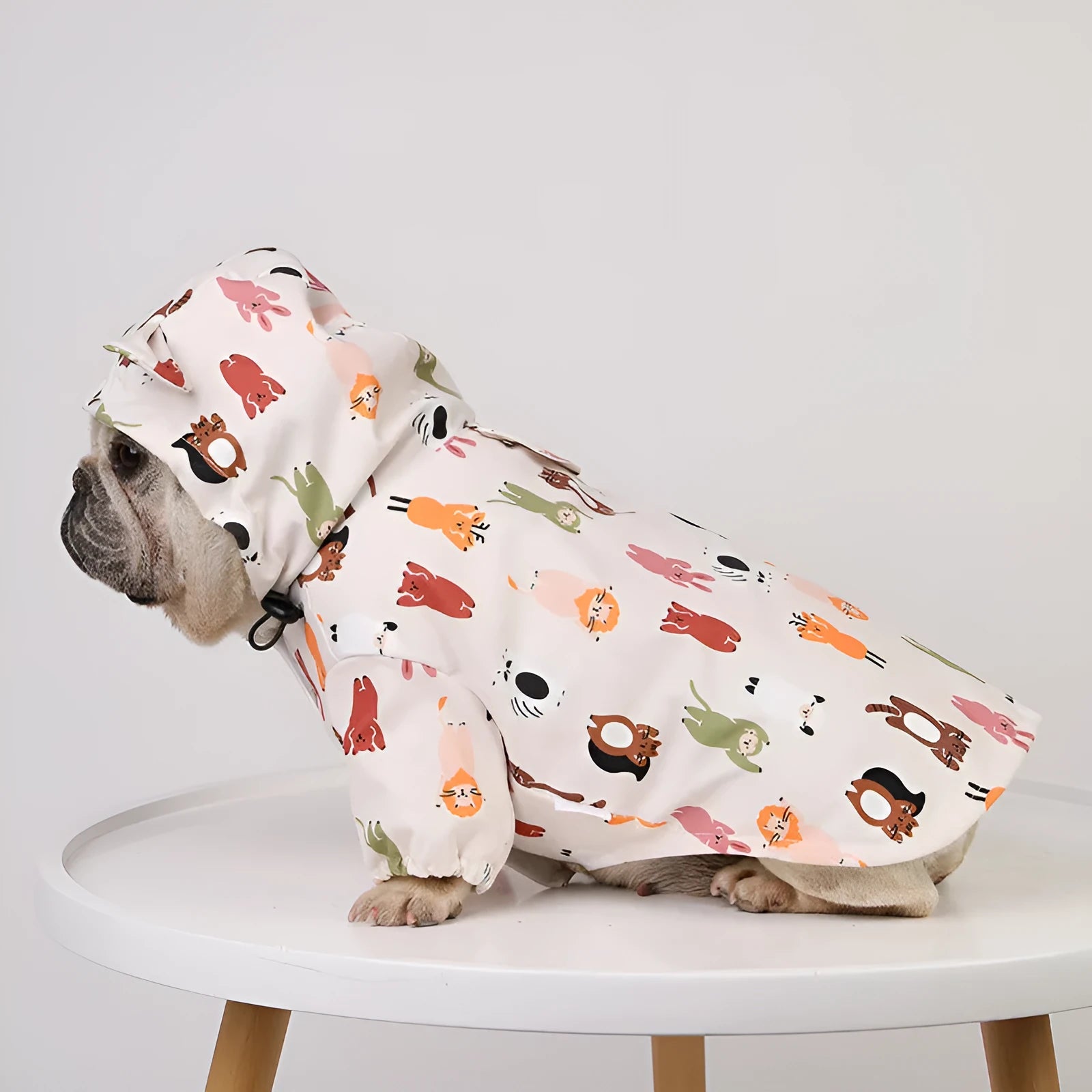 Beige dog raincoat with cartoon animal design in waterproof PU material