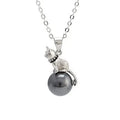 Close-up of a sterling silver cat silhouette pendant on a clavicle-length chain.