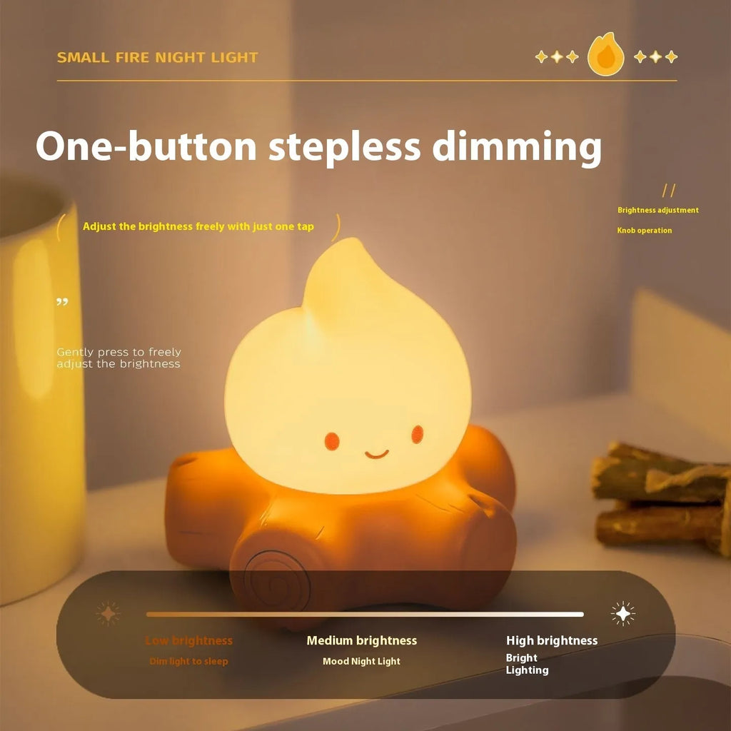 Small Fire Pile cartoon-themed silicone night light with yellow glow on a table.