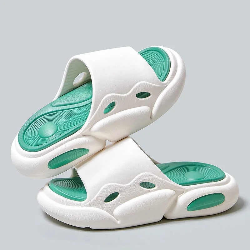 Two-colour EVA slippers for couples in pink and purple, shown on a wooden floor.
