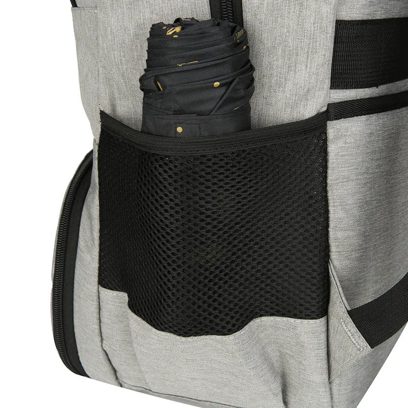 Light grey oxford cloth insulated backpack with curved shoulder straps and top handle.