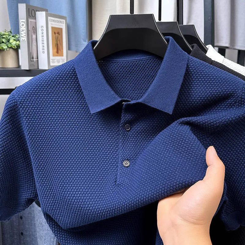 Man wearing a loose fit short sleeve cotton sweater in grey, showing the pullover style and relaxed silhouette.