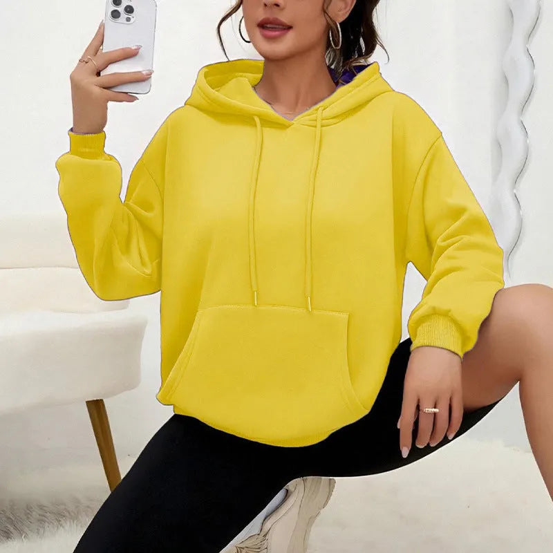 A loose-fitting women's long-sleeve sweatshirt with a drawstring pocket, shown in a solid colour.