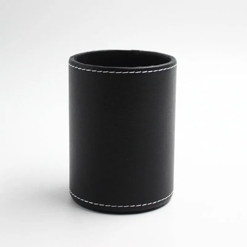 Round black leather pen holder on a desk