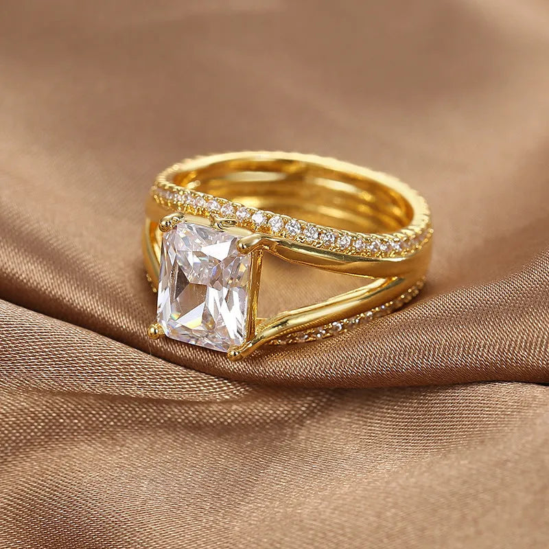 Geometric gold-coloured women's ring with square zircon stone on copper band