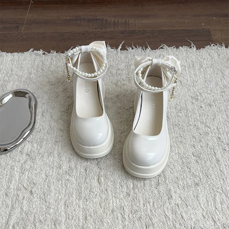 Beige and black women's Mary Jane shoes with a chunky round heel and round toe.