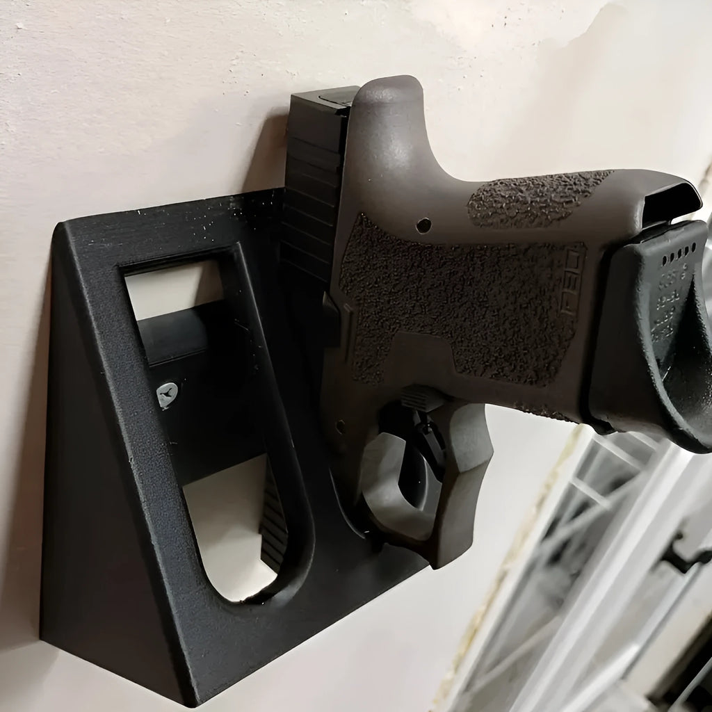 Black punk-style plastic pistol display stand measuring 10.85cm by 7.6cm