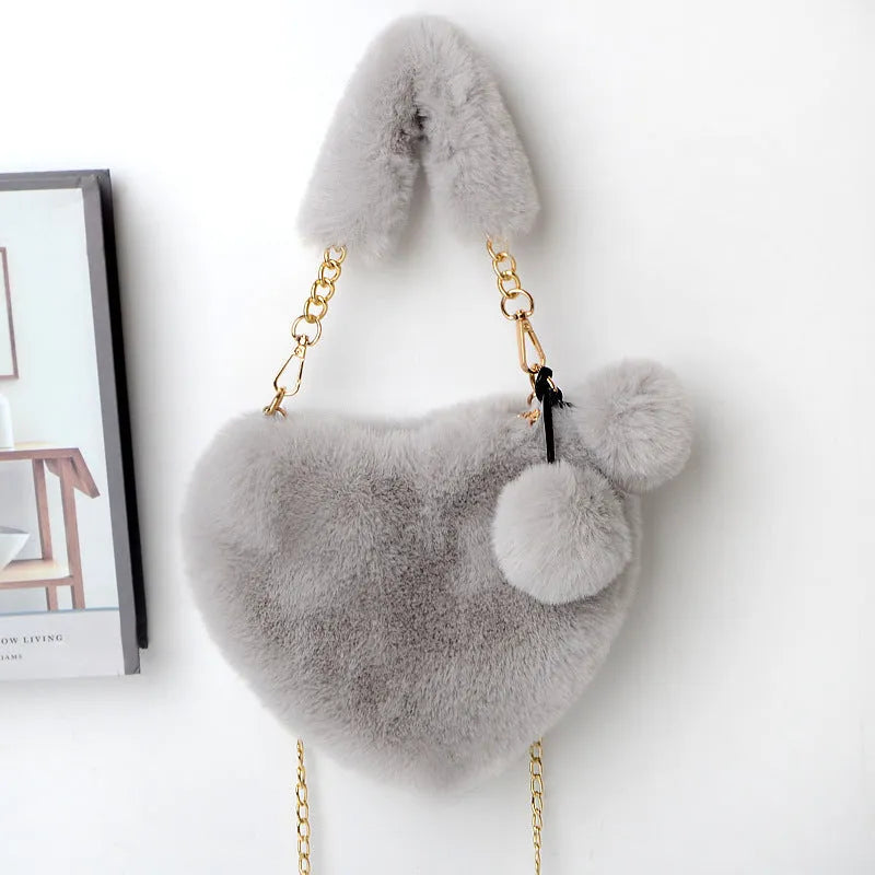 A soft plush heart-shaped women's handbag with a zipper and a detachable shoulder strap in a choice of 14 colours.