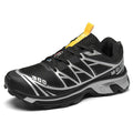 Low-top hiking shoes in khaki with rubber soles and front lace-up closure.