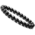 Close-up of a women's black onyx agate bracelet with 8mm geometric beads on a black elastic cord.