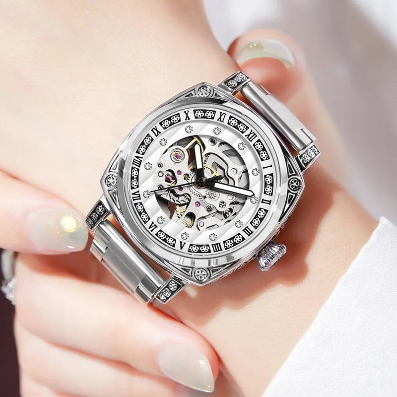 Leather strap mechanical watch with luminous hands on a wrist, showing black dial variant.