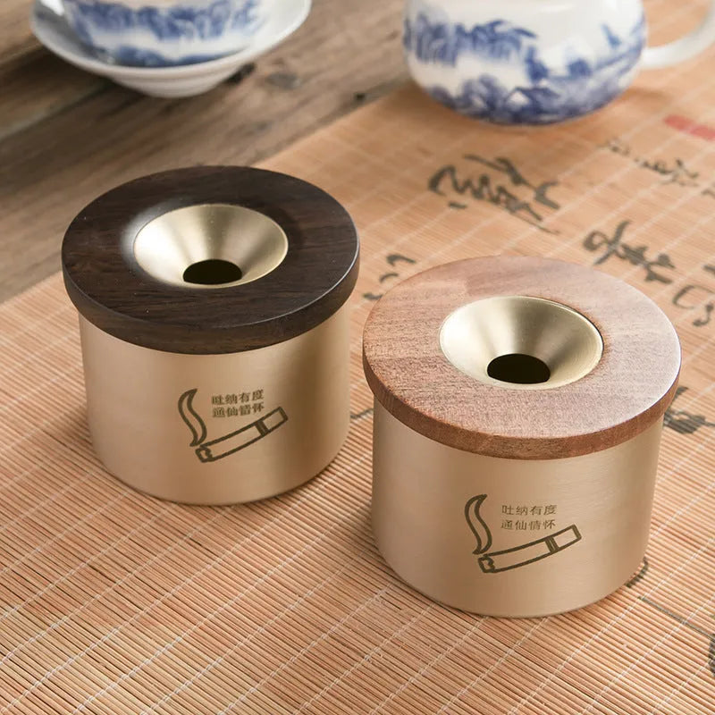 Brass ashtray with wooden lid in copper construction showing centre hole design