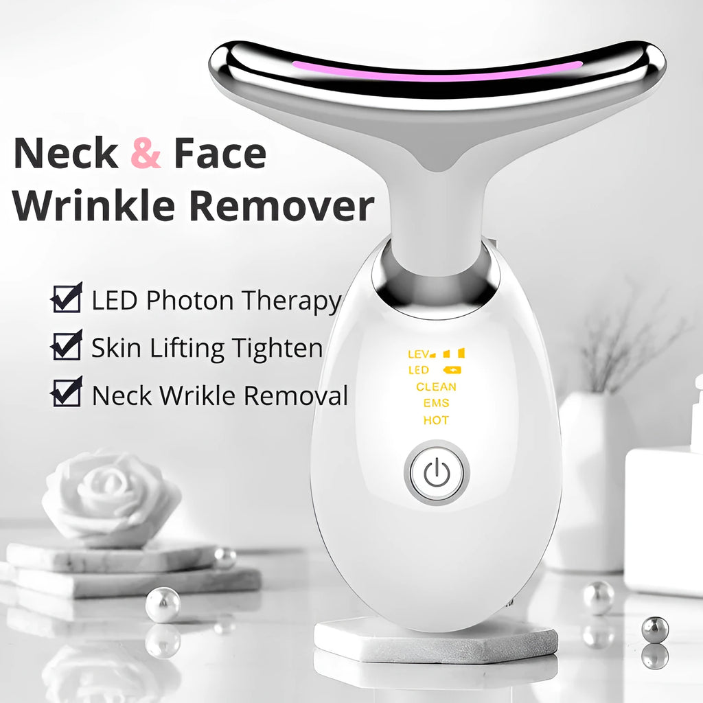 White EMS thermal neck massager with LED lights, shown with USB cable and moisturiser box