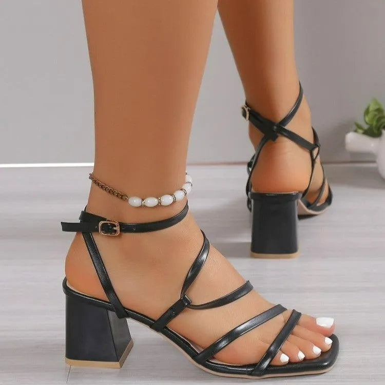 Plus size beige open toe slippers with a square toe and adjustable ankle buckle on a white background.