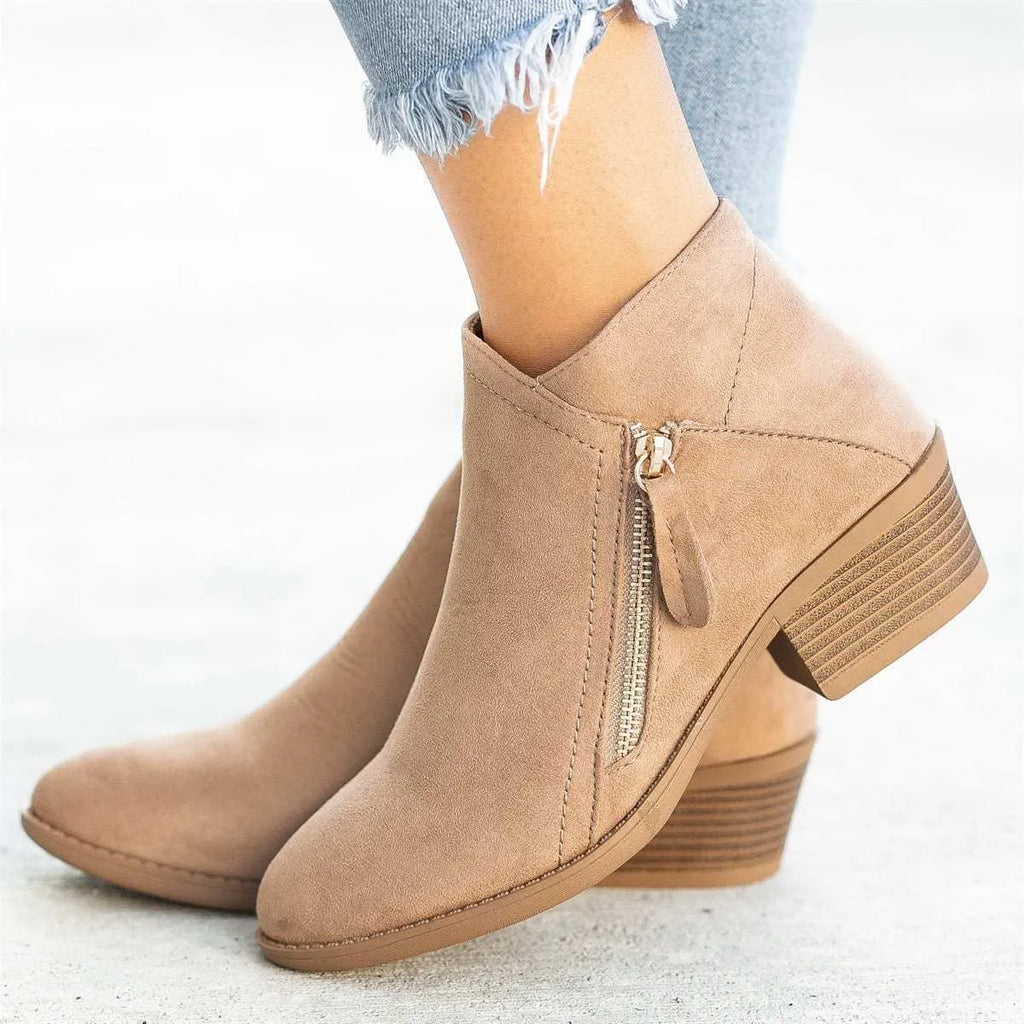 Women's beige suede chunky heel ankle boots with a side zip fastening, shown on a neutral background.