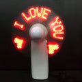 White handheld mini fan with flashing I love you LED pattern in blue and red lights