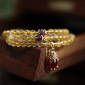 Brazilian Rutilated Quartz bracelet with gold beads and hanging chopsticks pendant