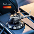 Silver metal solar helicopter car air freshener ornament with rotating blades on a car dashboard.