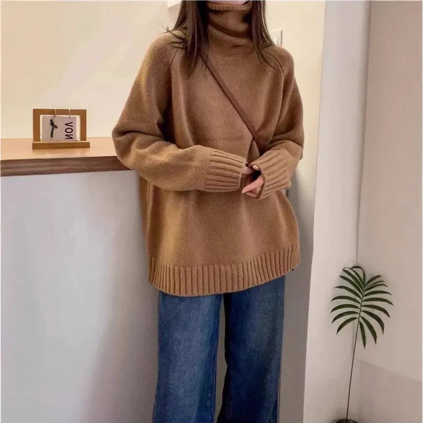Women's loose-fit turtleneck sweater with a thick, textured curling pile collar in a grey solid colour.