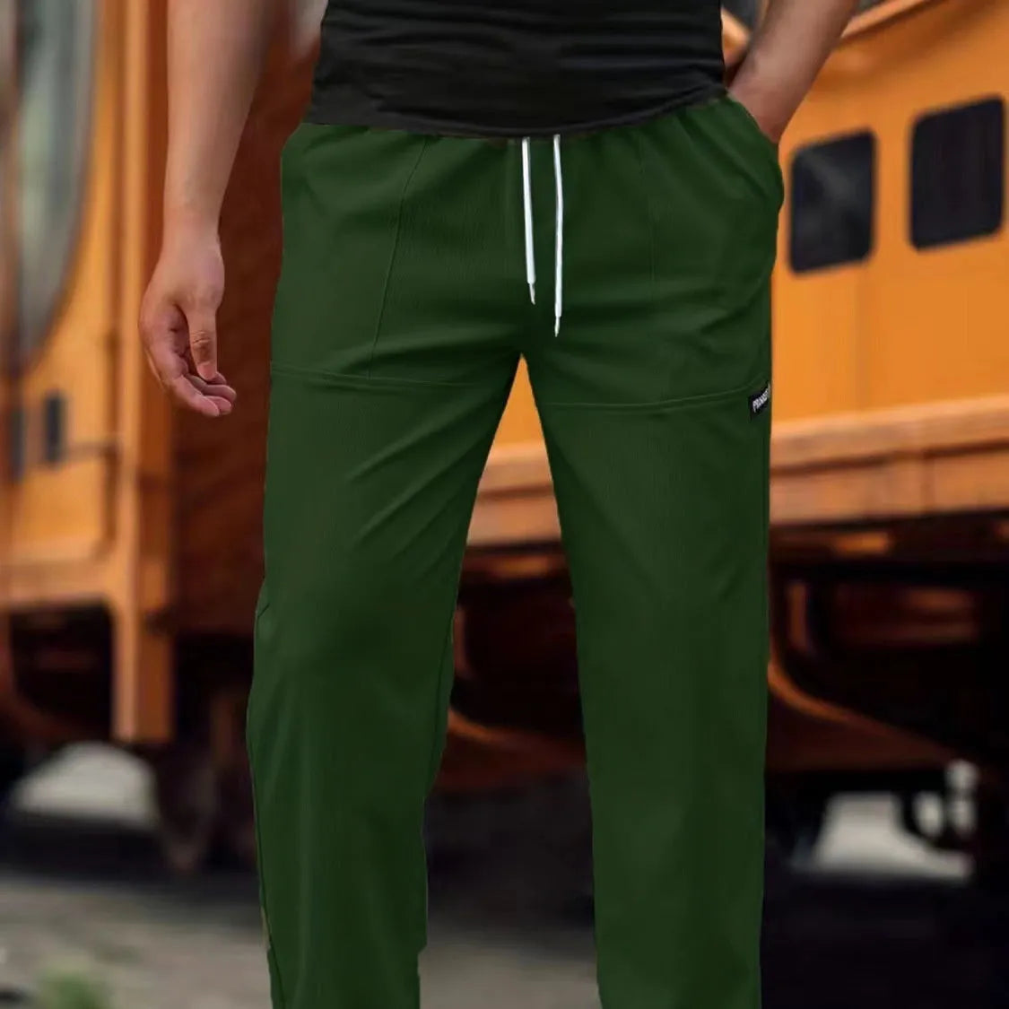 Men's straight-leg lightweight polyester trousers in light grey colour, laid flat showing front design