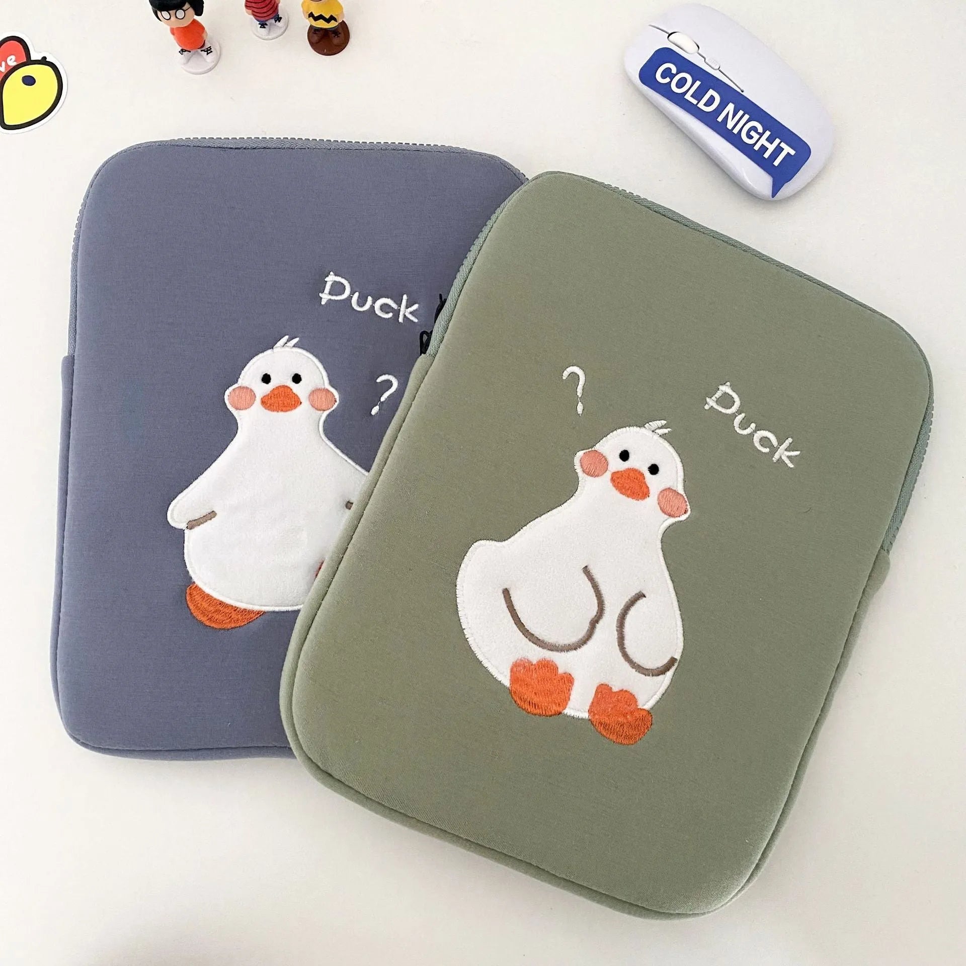Blue cotton tablet case with embroidered cartoon duck design and zipper closure