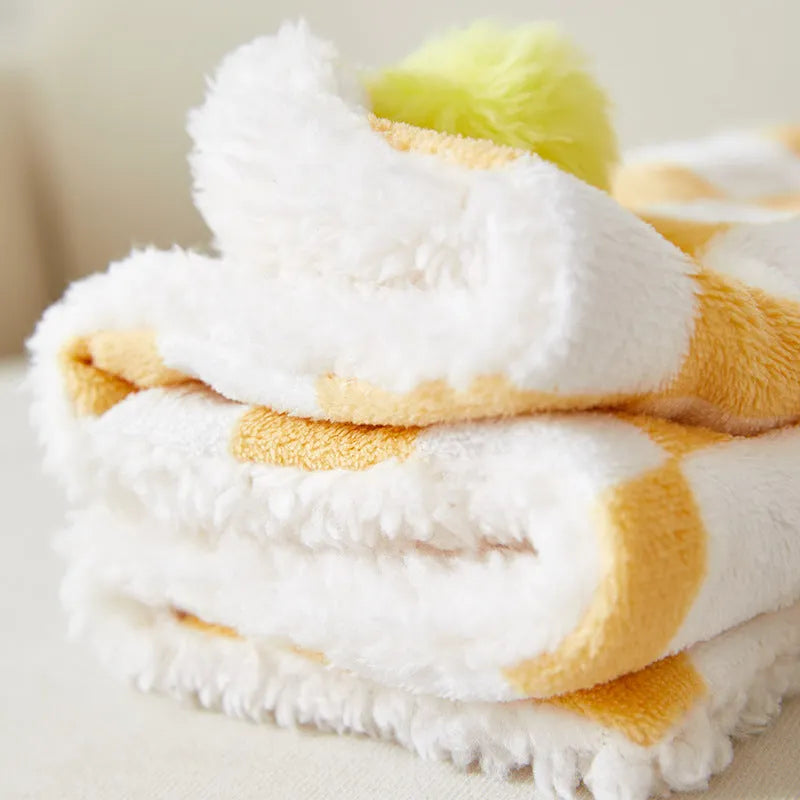 Plaid pattern pet blanket with fur ball trim on soft cotton fleece material for cats and dogs