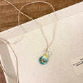 Women's necklace with Small Fish Lucky Bag glaze pendant on a cotton linen chain.