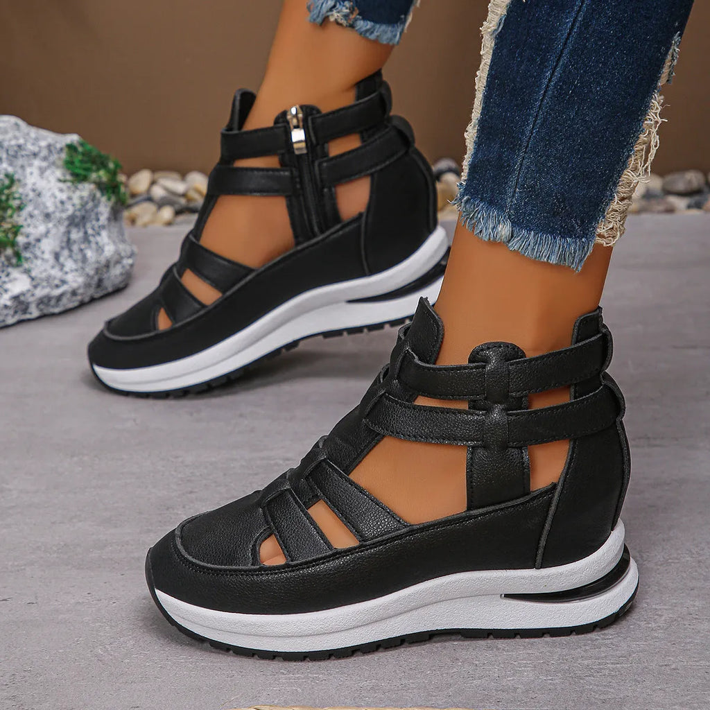 Women's black close-toed hollow-out platform sandals with a Velcro strap on a white background.