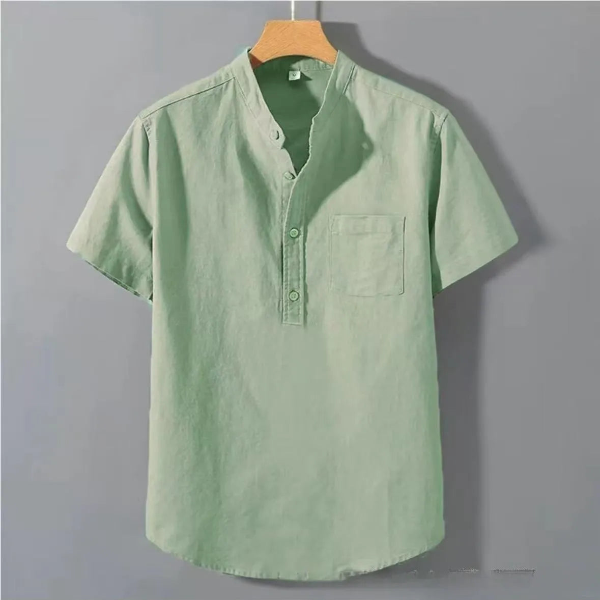 Men's casual beige linen short sleeve shirt with a stand collar and loose fit on a hanger.