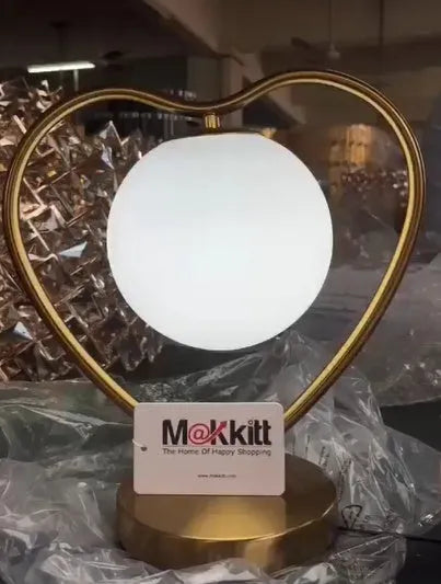 White heart shaped LED lamp with warm glow, shown on a surface