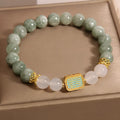 Oil green emerald crystal bracelet for women with five scripture charms on a white background.