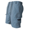 Man wearing loose straight-leg casual shorts in blue, showing the relaxed fit and straight cut.