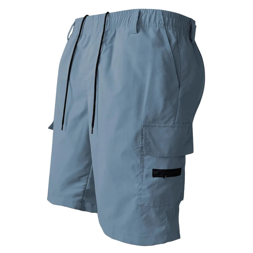 Man wearing loose straight-leg casual shorts in blue, showing the relaxed fit and straight cut.