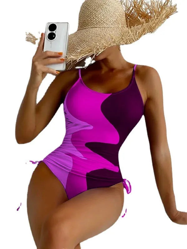 Women's sleeveless one-piece swimsuit in blue with backless design and striped pattern