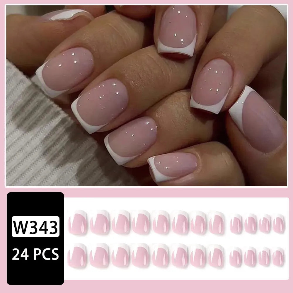24 white square fake nails with a black and white plaid pattern, laid out on a surface.