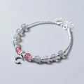 Handmade silver-tone adjustable bracelet with a 6mm moonstone bead and a small crescent moon charm.