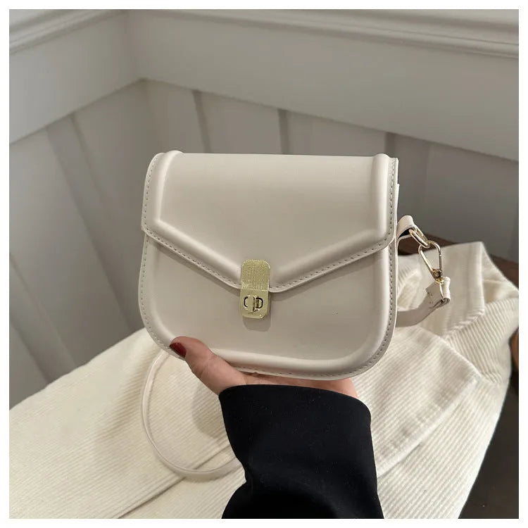 Soft textured PU shoulder messenger bag in horizontal square clamshell design.