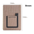 Erasable coil notebook with waterproof stone paper and erasable pen on desk