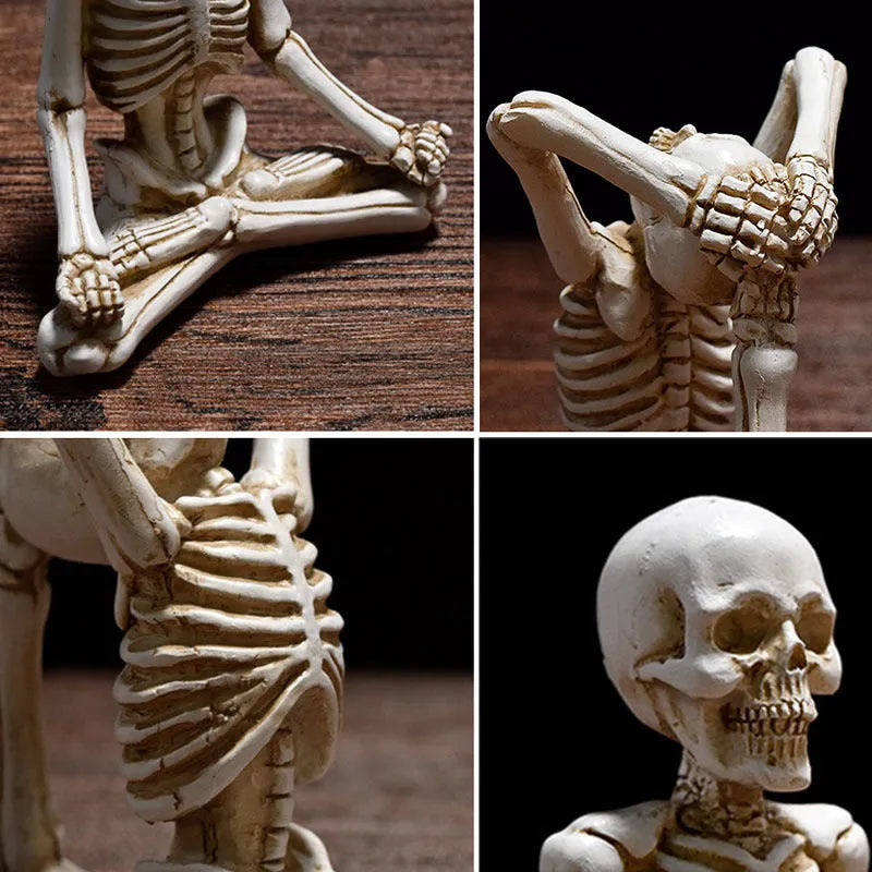 Detailed resin ornament of a yoga pose skeleton skull on a desktop, shown in black and white colour options.