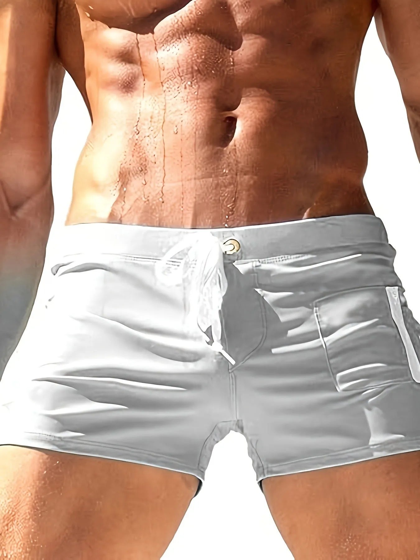 Men's black high-waisted swimming trunks with a white lace-up front detail, laid flat.