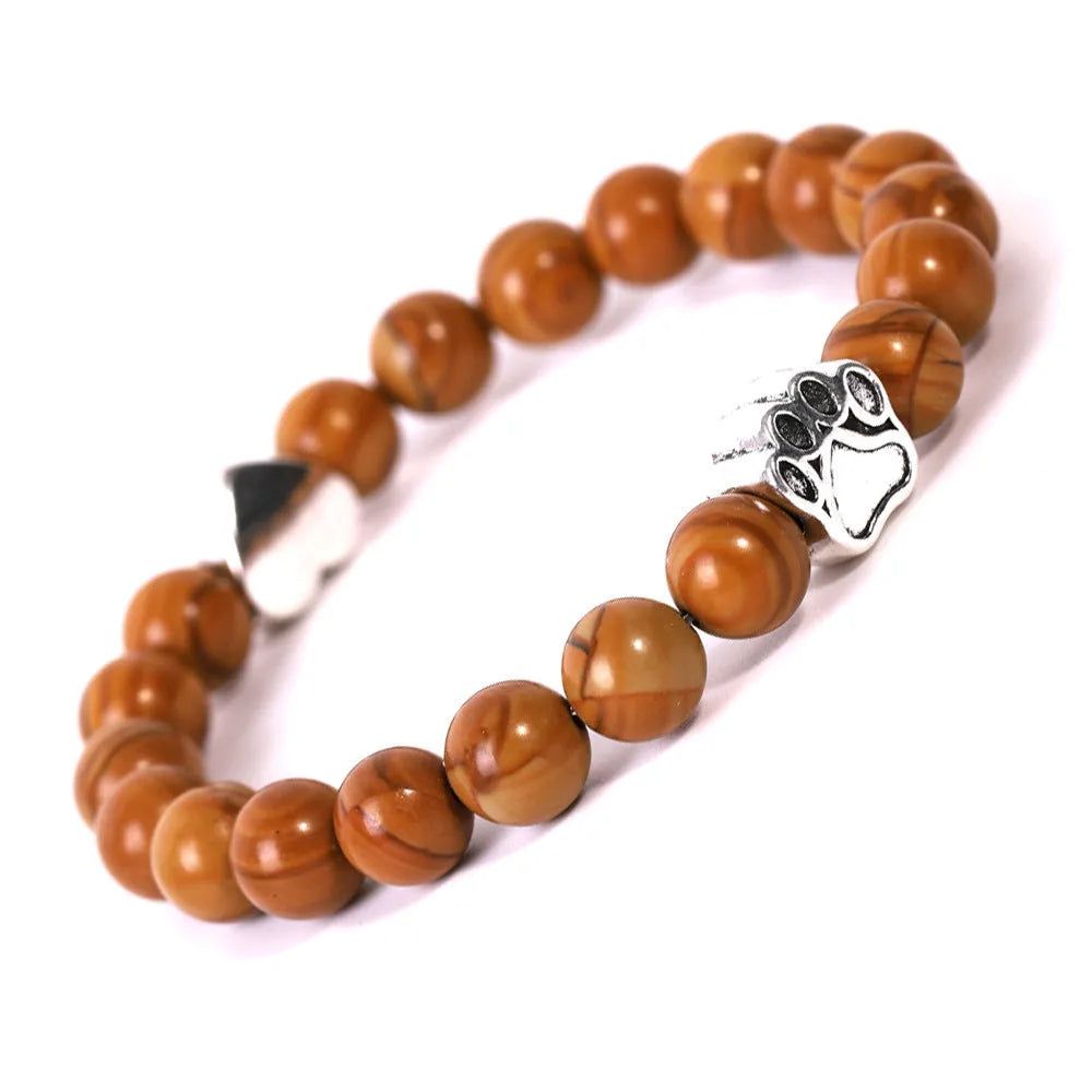 Tigereye Indian Agate stone bracelet with dog paw and love heart charms on wrist.