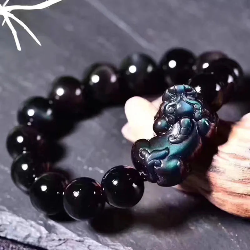 Natural ice colour eye obsidian crystal bracelet on an elastic band, showing bead detail.