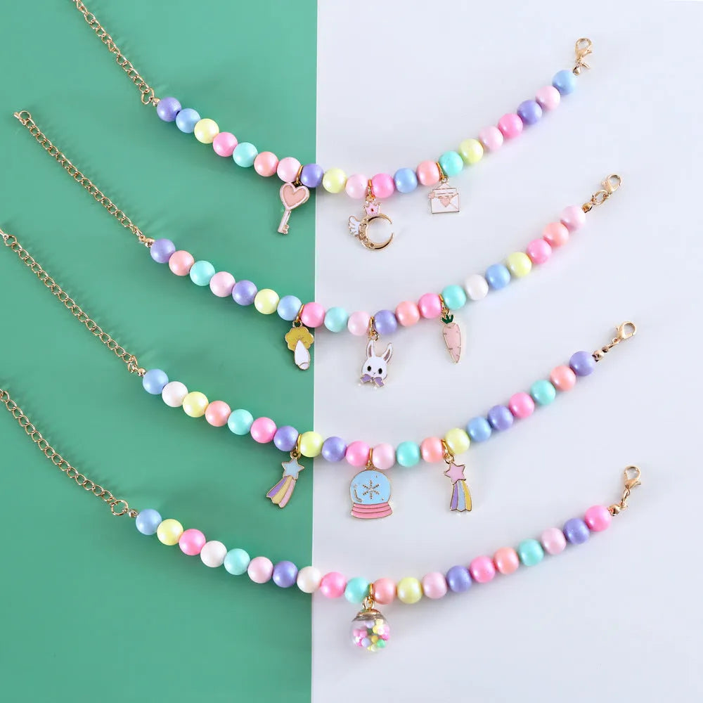 Macaron-colour pet collar with moon and pearl resin charms and a matching bracelet.