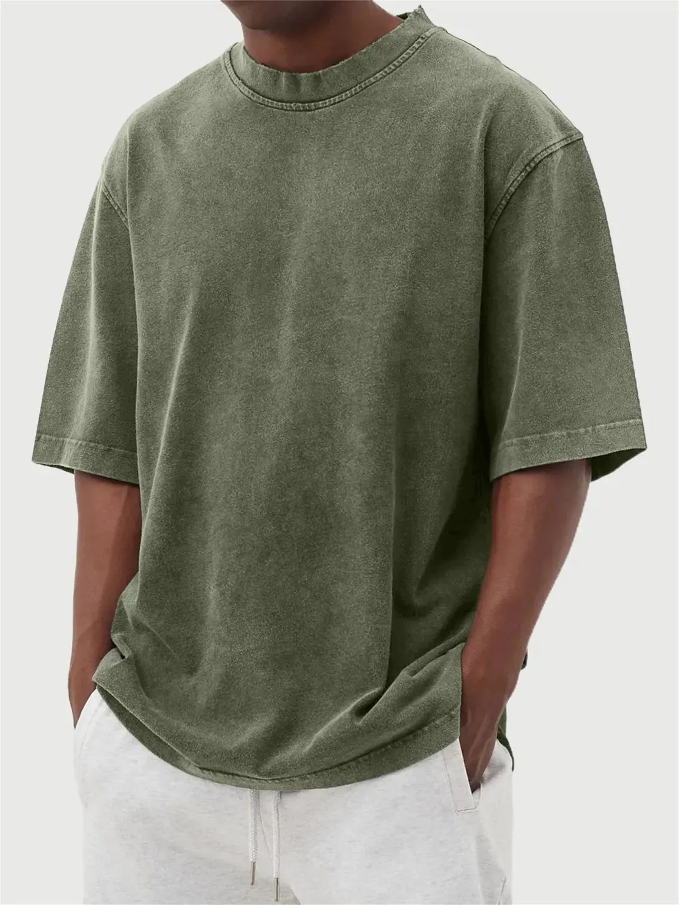 Men's loose fit pullover T-shirt in a stone-washed distressed solid colour, shown in army green.