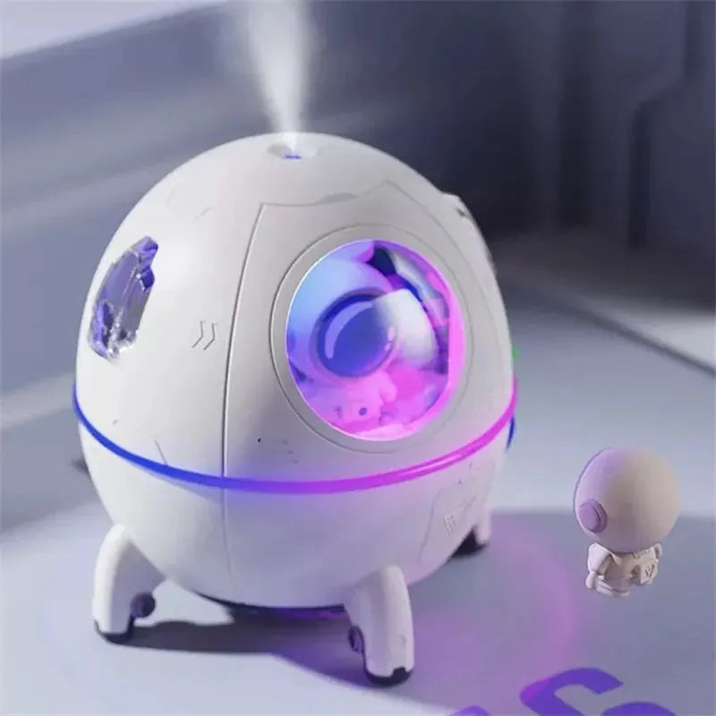 Light purple astronaut shaped USB humidifier with colourful LED light on a desk